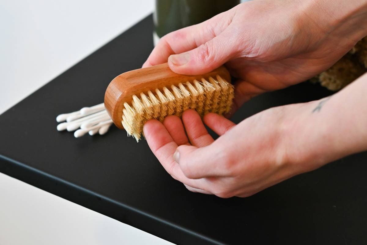 Diagram showing parts of a high-quality beard finishing brush: natural boar bristles, ergonomic wooden handle, compact head size for precision control