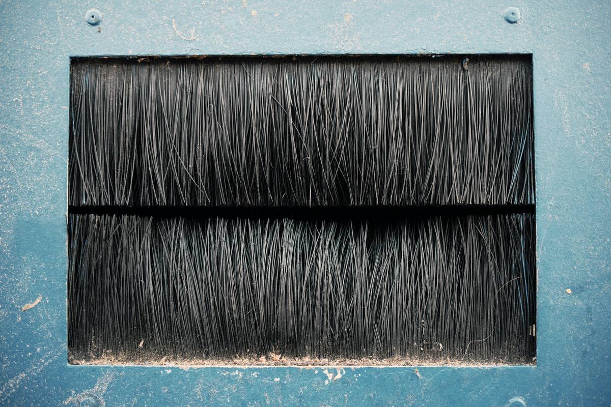 Side-by-side comparison of synthetic vs boar bristle beard brush showing bristle density and flexibility