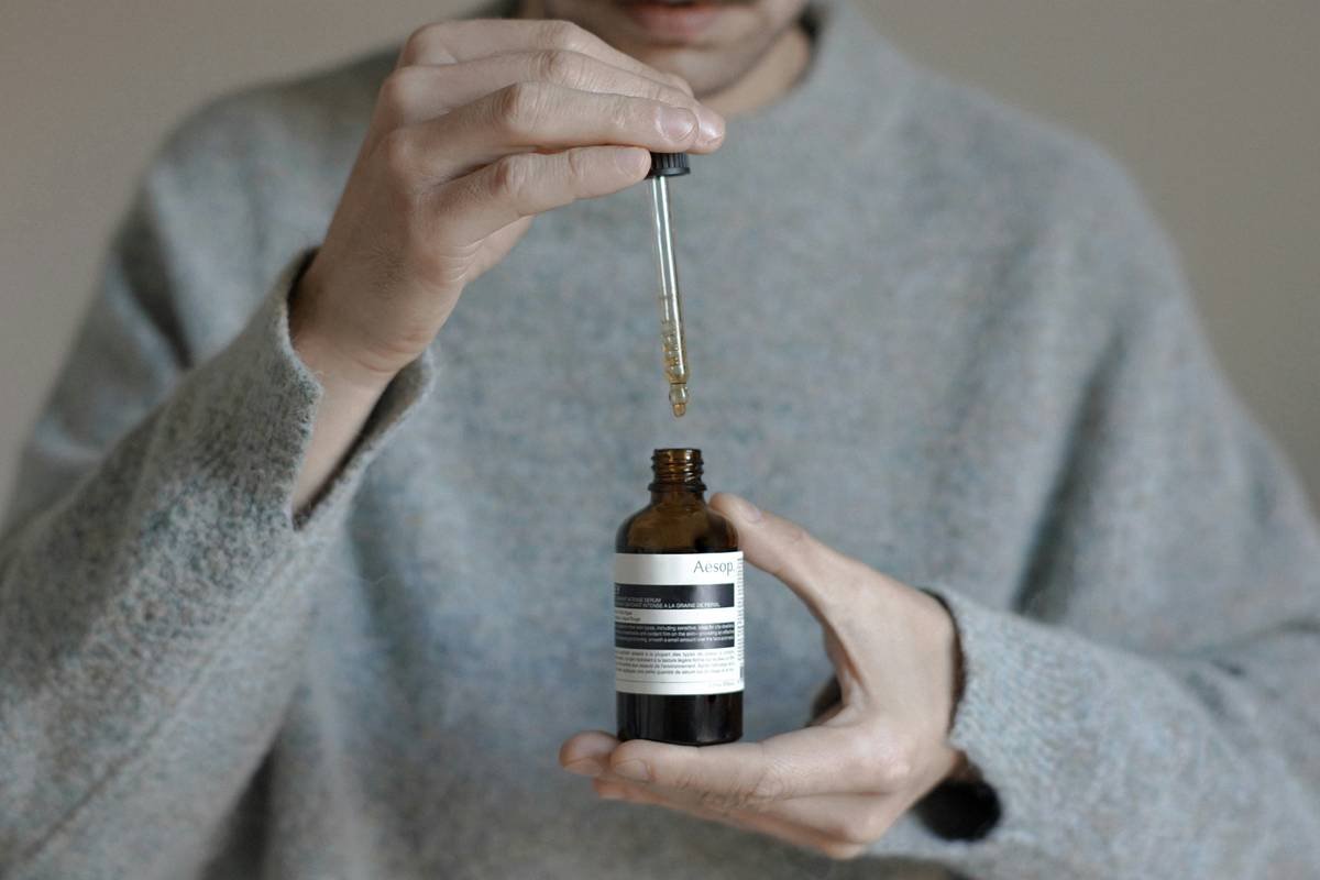 Man using beard hair nourishment brush on coarse, full beard with visible oil sheen