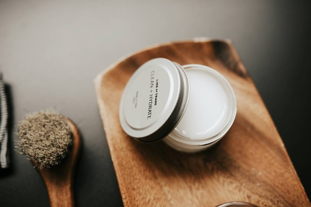 Man applying beard styling cream to damp beard with fingertips